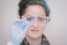 Christina Tringides, a senior at MIT and member of the research team, holds a sample of the multifunction fiber produced using the group’s new methodology.